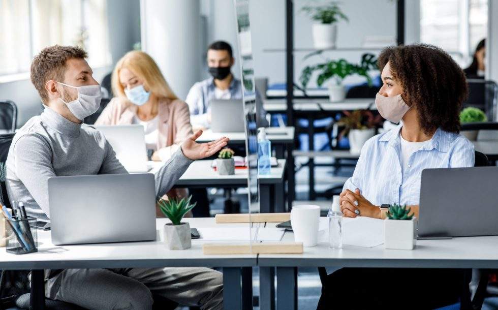 coworkers talking in a safe office environment